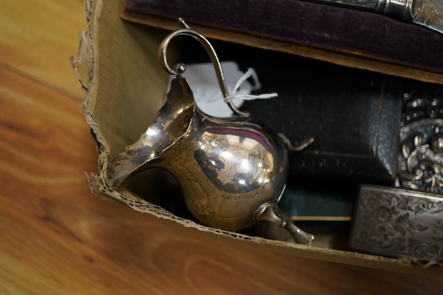 A group of small silver and white metal items including a late Victorian silver cream jug, a late Victorian silver mounted hand mirror, two continental 900 standard mounted small wall mirrors, a modern miniature silver t